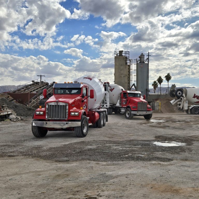 Mixer trucks at plant infront of silos