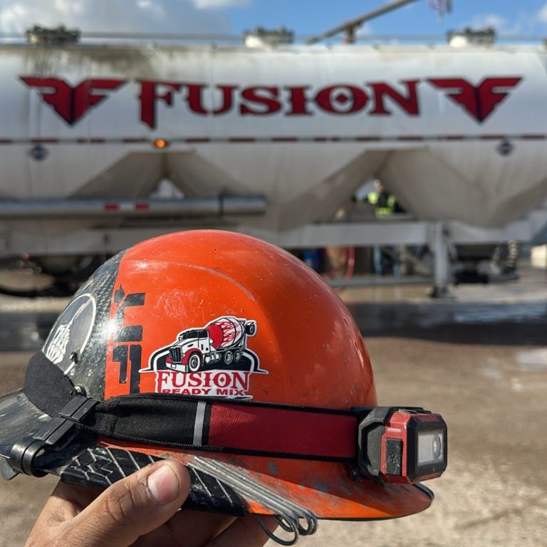 orange hard hat in front of powder truck